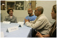 Laura Bush talks with, from left, Gabriel Flores, Archie Dominguez and Shirley Torres during a discussion at Homeboy Industries in Los Angeles April 27, 2005. Homeboys Industries is an job-training program that educates, trains and finds jobs for at-risk and gang-involved youth.