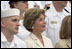 Laura Bush listens to President George W. Bush speak during a ceremony to commemorate the 60th anniversary of V-J Day at the Naval Air Station in San Diego, Calif., August 30, 2005.