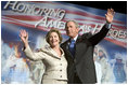 President George W. Bush and Laura Bush wave to the crowd of military families, Wednesday, Aug. 24, 2005 at the Idaho Center Arena in Nampa, Idaho, following the President's speech honoring the service of National Guard and Reserve forces serving in Afghanistan and Iraq.