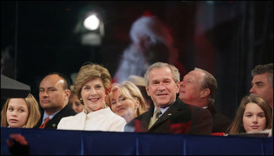 President George W. Bush and Laura Bush watch the holiday entertainment, Thursday evening, Dec. 1, 2005, during the Pageant of Peace and the lighting of the National Christmas Tree on the Ellipse in Washington.