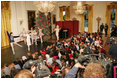 Sitting with children, President and Laura Bush watch the American Ballet Company perform part of the Holiday classic, "The Nutcracker," during the Children's Holiday Reception in the East Room Monday, Dec. 5, 2005.