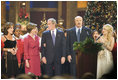 President and Mrs. Bush sing "Hark, the Herald Angels Sing!" along with Dr. Phil McGraw, his wife Robin, left, and Carrie Underwood, right, during the 24th Annual Christmas in Washington at the National Building Museum in downtown Washington D.C.