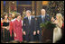 President and Mrs. Bush sing "Hark, the Herald Angels Sing!" along with Dr. Phil McGraw, his wife Robin, left, and Carrie Underwood, right, during the 24th Annual Christmas in Washington at the National Building Museum in downtown Washington D.C.