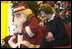 Laura Bush talks with children from New Orleans neighborhoods as she sits with Santa Claus, Monday Dec. 12, 2005 at the Celebration Church in Metairie, La., during a Toys for Tots event.