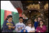 Laura Bush and children from New Orleans neighborhoods react to a downpour of fake snow flakes, Monday Dec. 12, 2005 at the Celebration Church in Metairie, La., during a Toys for Tots event.