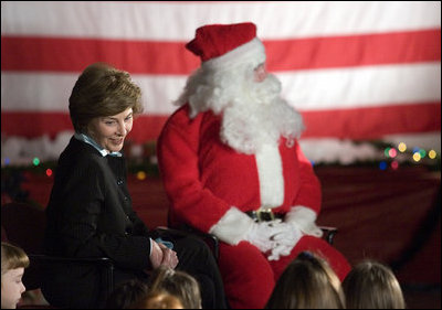 Laura Bush talks with a group of children as she visits the Naval and Marine Corps Reserve Center in Gulfport, Miss., Monday, Dec. 12, 2005, where she showed them White House holiday video featuring the Bush's dogs "Barney and Miss Beazley."