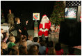 Laura Bush visits with children at the Naval and Marine Corps Reserve Center in Gulfport, Miss., Monday, Dec. 12, 2005, showing them a White House holiday video featuring the Bush's dogs "Barney and Miss Beazley."