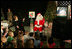 Laura Bush visits with children at the Naval and Marine Corps Reserve Center in Gulfport, Miss., Monday, Dec. 12, 2005, showing them a White House holiday video featuring the Bush's dogs "Barney and Miss Beazley."