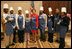 Mrs. Laura Bush and students at Cardozo Senior High School pose for pictures Monday, Dec. 19, 2005, in Washington, D.C. Mrs. Bush was on hand to join the Youth Services Opportunities Project in assembling sandwiches for Martha's Table's mobile soup kitchen.