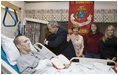 As Laura Bush looks on, President George W. Bush hugs Candy Pierson of Auburndale, Fla., after her son, Marine Cpl Jordan S. Pierson, was presented the Purple Heart for injuries suffered while serving in Iraq. The ceremony took place Wednesday, Dec. 21, 2005, at the National Naval Medical Center in Bethesda, Md. Also in the room are Cpl. Pierson's fiancée, Kirstin Martin, right, and cousin Tiffany Pierson.