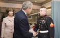 President George W. Bush shakes the hand of Marine Cpl. Andrew L. Tinsley of Annapolis, Md., Wednesday, Dec. 21, 2005, after Cpl Tinsley was presented the Purple Heart during a visit by the President and Laura Bush to the National Naval Medical Center in Bethesda, Md.