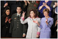 Safia Taleb al-Suhail, leader of the Iraqi Women's Political Council, second on right, displays a peace sign as other guests applaud during President George W. Bush's State of the Union speech at the U.S. Capitol, Wednesday, Feb. 2, 2005. Also pictured are, from left, Kindergarten teacher Lorna Clark of Santa Theresa, New Mexico, Army Staff Sergeant Norbert Lara, and Laura Bush.