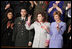 Safia Taleb al-Suhail, leader of the Iraqi Women's Political Council, second on right, displays a peace sign as other guests applaud during President George W. Bush's State of the Union speech at the U.S. Capitol, Wednesday, Feb. 2, 2005. Also pictured are, from left, Kindergarten teacher Lorna Clark of Santa Theresa, New Mexico, Army Staff Sergeant Norbert Lara, and Laura Bush.