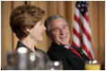 President George W. Bush and Laura Bush laugh during the National Prayer Breakfast in Washington, D.C., Thursday, Feb. 3, 2005.