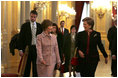 Laura Bush walks with Queen Paola of Belgium during a tour of the Royal Palace of Belgium in Brussels Monday, Feb. 21, 2005.