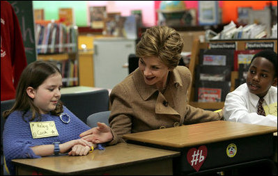 Mrs. Bush greets Hainerberg Elementary School student Hailey Cook during her visit with fourth and fifth graders Tuesday, Feb. 22, 2005 in Wiesbaden, Germany.