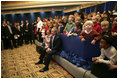 President George W. Bush and Laura Bush sit with children of embassy staff during their visit with U.S. Embassy employees Monday, Feb. 21, 2005, at the Sheraton Brussels Hotel and Towers in Brussels.