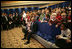 President George W. Bush and Laura Bush sit with children of embassy staff during their visit with U.S. Embassy employees Monday, Feb. 21, 2005, at the Sheraton Brussels Hotel and Towers in Brussels.