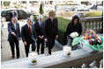 Laura Bush approaches a candle-lit memorial honoring the victims of the recent tsunami at the Embassy of Indonesia during a visit with President George W. Bush and former Presidents Bush and Clinton in Washington, D.C., Monday, Jan. 3, 2005.