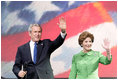 President George W. Bush and Laura Bush wave to young supporters during the pre-inaugural event 'America's Future Rocks Today- A Call to Service' youth event at the DC Armory in Washington, D.C., Tuesday, Jan. 18, 2005. The event highlighted the importance of volunteerism and community service in America's neighborhoods.