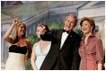 With his twin daughters Jenna, left, and Barbara by his side, President George W. Bush points out members of the audience to Laura Bush during a Black Tie and Boots Inaugural Ball in Washington, D.C., Wednesday, Jan. 19, 2005.