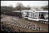 A procession of motorcycles leads the Inaugural Parade down Pennsylvania Avenue past the President's reviewing stand in front of the White House, Jan. 20, 2005. President George W. Bush and Laura Bush traveled with the parade after a swearing-in ceremony for the President at the U.S. Capitol.