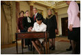 Secretary of State Dr. Condoleezza Rice signs official papers Friday, Jan. 28, 2005, after receiving the oath of office during her ceremonial swearing in at the Department of State. Watching on are, from left, Laura Bush, Justice Ruth Bader Ginsburg, President George W. Bush and an unidentified family member.