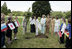 Mrs. Laura Bush looks on as Cherie Blair, wife of Prime Minister Tony Blair, takes the first dig during a tree-planting ceremony Thursday, July 7, 2005, at Glamis Castle, Scotland.