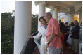 On July 4, 2005, President and Mrs. Bush listen as a South Lawn crowd sings "Happy Birthday" at the White House in celebration of the President's upcoming birthday on July 6.