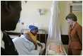 Laura Bush visits with a mother and her newborn baby while meeting with the group, "Mothers to Mothers-to-Be," in Cape Town, South Africa, Tuesday, July 12, 2005. The program provides support to HIV-positive women during their pregnancy.