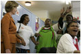 Laura Bush is greeted by a chorus of singers while visiting Mothers to Mothers-to-Be in Cape Town, South Africa, Tuesday, July 12. The program provides counseling, education and support to HIV/AIDS infected women during pregnancy.