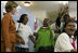 Laura Bush is greeted by a chorus of singers while visiting Mothers to Mothers-to-Be in Cape Town, South Africa, Tuesday, July 12. The program provides counseling, education and support to HIV/AIDS infected women during pregnancy.