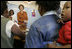 Laura Bush visits with women involved with the program, "Mothers to Mothers-to-Be," in Cape Town, South Africa, Tuesday, July 12. The program provides counseling, education and support to HIV/AIDS infected women during pregnancy.