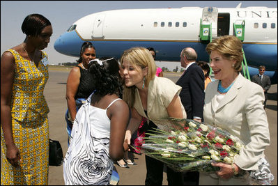 Laura Bush and daughter Jenna Bush are greeted at an arrival ceremony Thursday, July 14, 2005 at Kigali International Airport in Kigali, Rwanda.