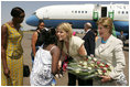 Laura Bush and daughter Jenna Bush are greeted at an arrival ceremony Thursday, July 14, 2005 at Kigali International Airport in Kigali, Rwanda.