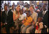 Laura Bush and daughter Jenna sit with children as they visit the Kagarama Church, Thursday, July 14, 2005, in Kigali, Rwanda.