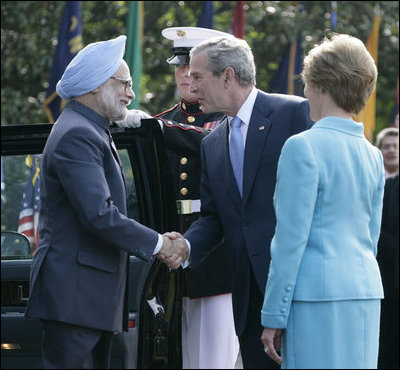 President George W. Bush and Laura Bush welcome India's Prime Minister Dr. Manmohan Singh upon his arrival to the White House, Monday, July 18, 2005.