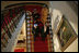 President George W. Bush, Laura Bush and India's Prime Minister Dr. Manmohan Singh and Mrs. Gursharan Kaur walk down the stairs to the State Dining Room, Monday, July 18, 2005 at the White House, for the official dinner in honor of the visit by India's Prime Minister Dr. Manmohan Singh.