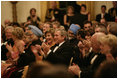 President George W. Bush, Laura Bush and India Prime Minister Dr. Manmohan Singh and Mrs. Gursharan Kaur, applaud the entertainers appearing Monday, July 18, 2005 at the official dinner at the White House.