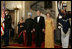 President George W. Bush, Laura Bush and India Prime Minister Dr. Manmohan Singh and Mrs. Gursharan Kaur, arrive for the official dinner in the State Dining Room at the White House Monday, July 18, 2005.