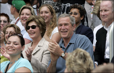 President George W. Bush and Mrs. Laura Bush cheer on players during a Tee Ball game on the South Lawn of the White House between the District 12 Little League Challengers from Williamsport, PA and the West University Little League Challengers from Houston, Texas on Sunday July 24, 2005.