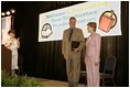 Laura Bush and her brother-in-law Florida Gov. Jeb Bush are applauded upon their arrival at the Teen Trendsetters Reading Mentors 2005 Annual Summit, July 26, 2005 at the Wyndham Orlando Resort in Orlando, Florida.