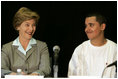 Laura Bush talks with Freddy Martinez, 17, during a roundtable discussion on stopping violent crime in Chicago on June 2, 2005. CeaseFire Chicago is a public health initiative that works with community partners to reduce violence.