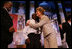 Laura Bush attends the Opening Session of the 2005 National Big Brothers Big Sisters Conference, June 9, 2005, at the Marriott Wardman Park Hotel. Washington, D.C. On-stage participants include: Vincent "Vinny" Thomas, Big Brother, left, ; and Parry Elliott, Little Brother, 13-years-old, being embraced by Mrs. Bush.