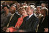 President George W. Bush, Laura Bush and HUD Secretary Alphonso Jackson, pictured at right, listen to performers during the White House reception honoring June as Black Music Month in the East Room Monday, June 6, 2005.