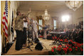 President George W. Bush and Laura Bush listen to performers during the White House reception honoring June as Black Music Month in the East Room Monday, June 6, 2005. Gospel artists Smokie Norful, Mary Mary and Reverend Donnie McClurkin performed during the ceremony.