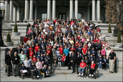 Laura Bush stands with country singer LeAnn Rimes, actor LeVar Burton and representatives of the Children's Miracle Network on the steps of the Dwight D. Eisenhower Executive Office Building near the White House Friday, March 18, 2005.