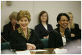 Laura Bush and Secretary of State Condoleezza Rice laugh during a roundtable discussion with women leaders from around the world held in honor of International Women's Day at the State Department in Washington, D.C. Tuesday, March 8, 2005. Today in her remarks at the State Department Mrs. Bush said, "We all have an obligation to speak for women who are denied their rights to learn, to vote or to live in freedom. We may come from different backgrounds, but advancing human rights is the responsibility of all humanity, a commitment shared by people of goodwill on every continent."