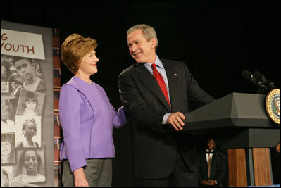 President George W. Bush and Laura Bush laugh as he introduces her during her remarks on Helping America's Youth at the Community College of Allegheny County in Pittsburgh Monday, March 7, 2005.