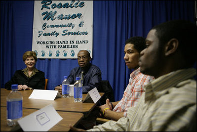 Laura Bush talks with young fathers who have turned their lives around with the help of the Today's Dad program at Rosalie Manor Community and Family Services center in Milwaukee, Wis., Tuesday, March 8, 2005.